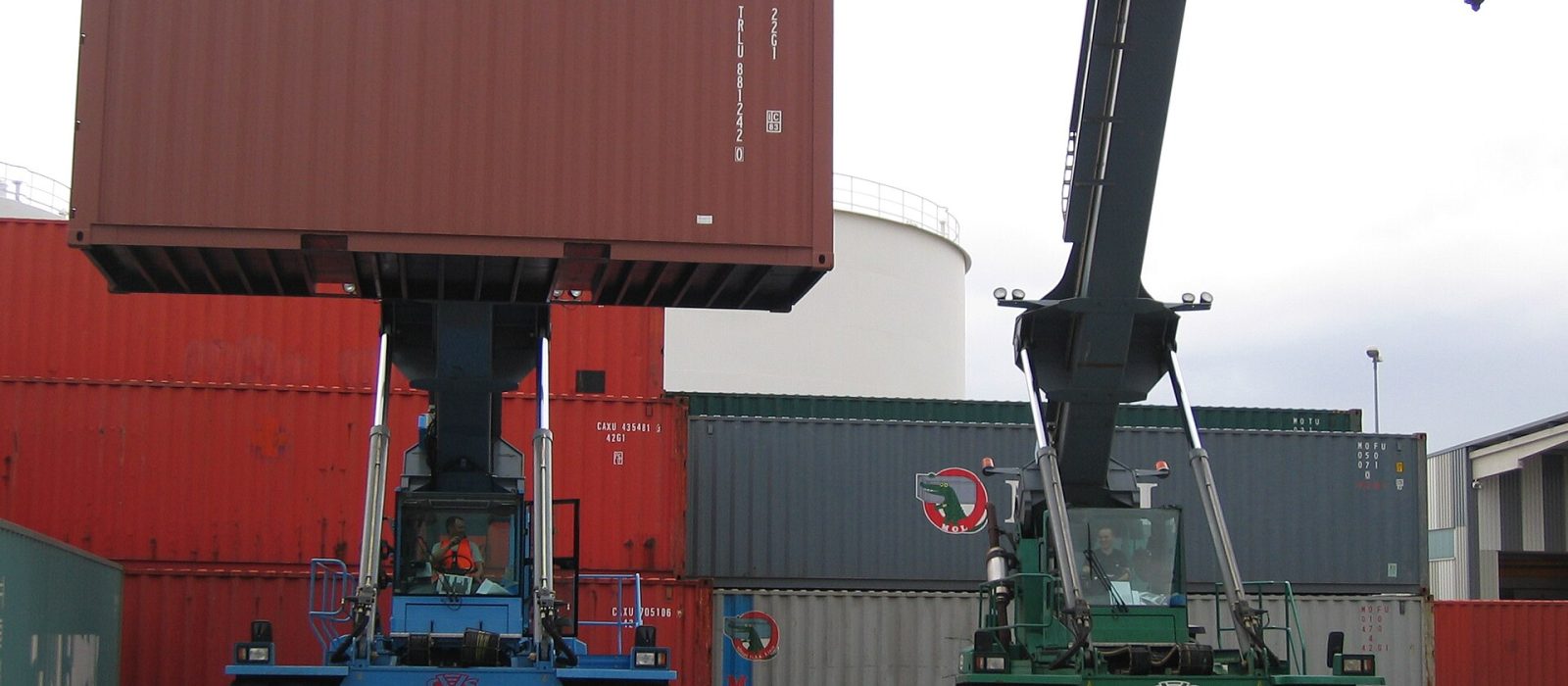 A reach stacker lifting a container clear of a stack