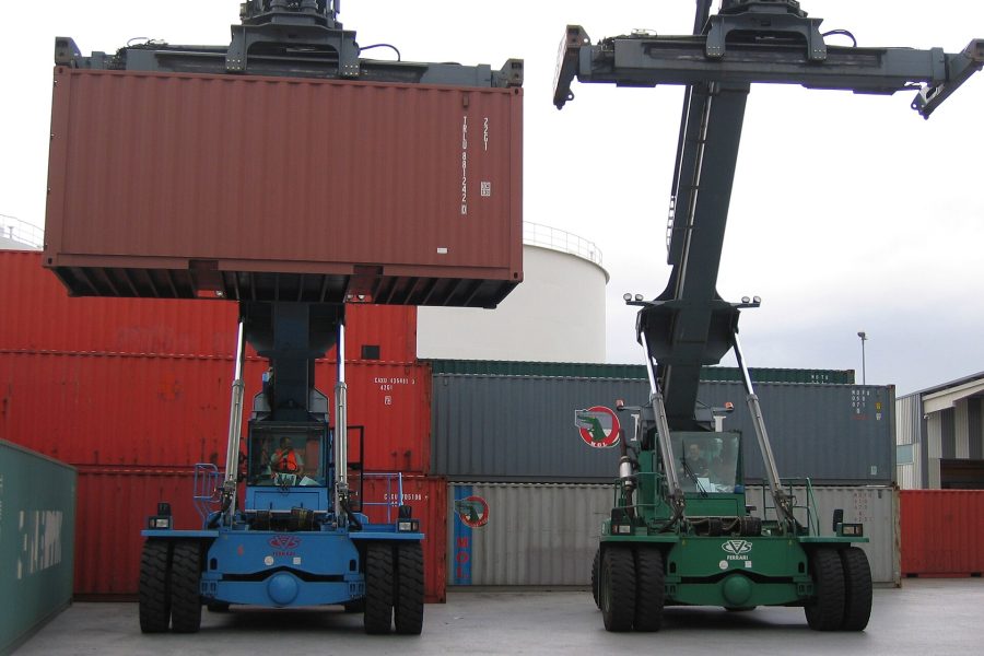A reach stacker lifting a container clear of a stack