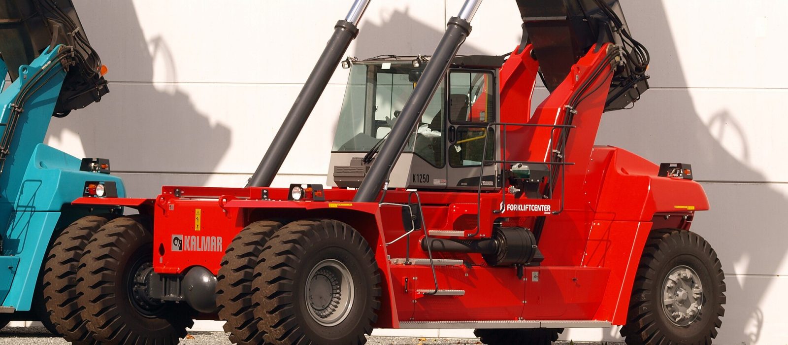 A heavy reach stacker with its boom raised